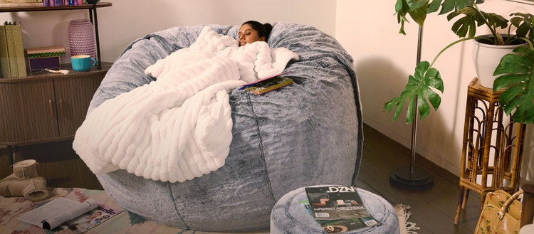 Person sleeping in a large, Lovesac, bean bag chair