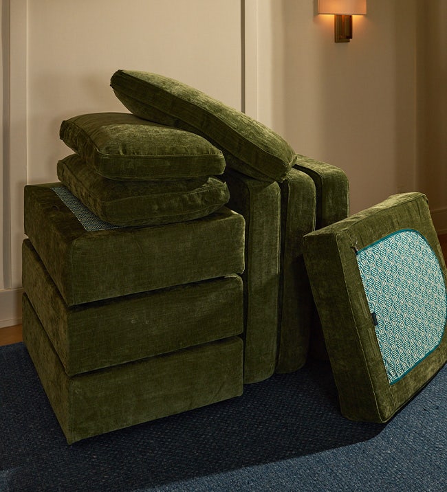 Person rearranging their Lovesac sectional couch pieces.