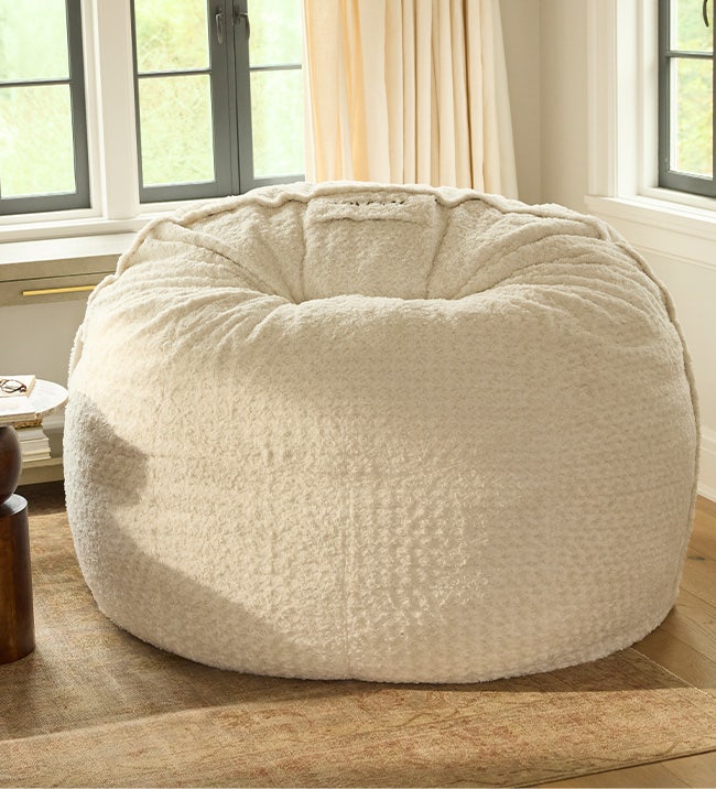 Mother and child relaxing in a Lovesac bean bag chair.