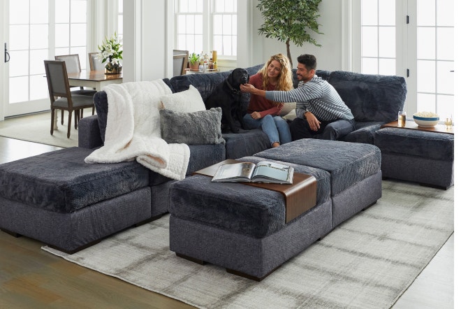 People and dog relaxing on an 8 Seats + 5 Sides Lovesac Sactionals couch.