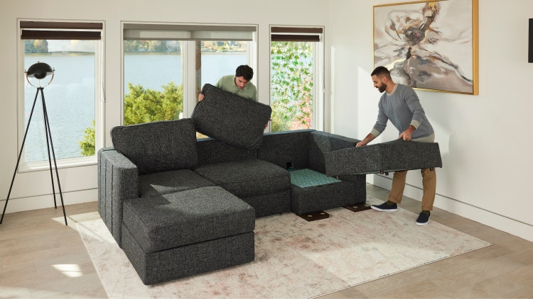 Two men putting a Sactionals couch together