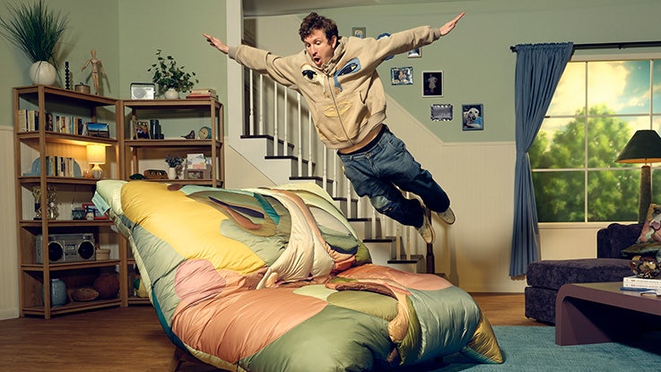 KidSuper jumping on the Kissing Design Lovesac PillowSac Accent Chair