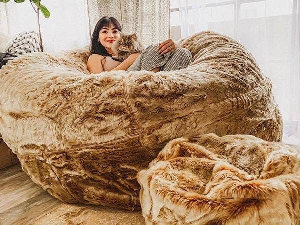 Girl and cat resting on a beanbag