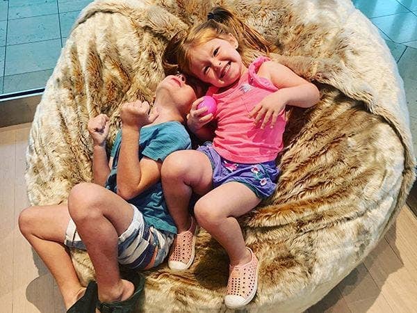 Two kids playing on a beanbag