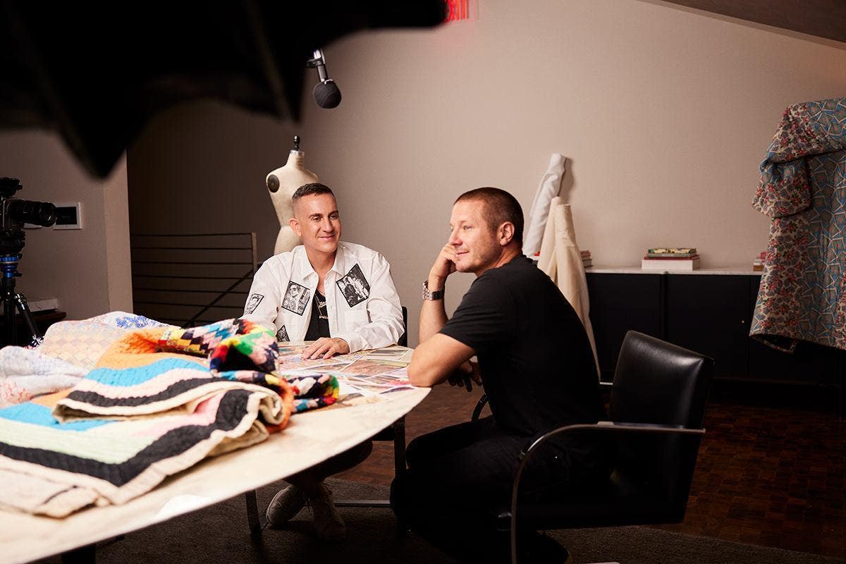 Jeremy Scott and Shawn Nelson talking during a photoshoot.