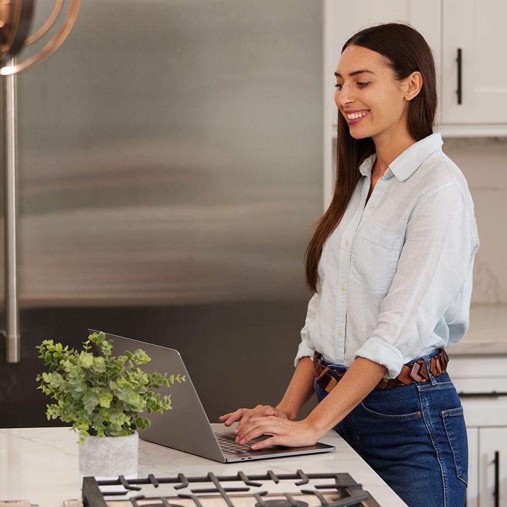 Women scheduling an appointment using her laptop.