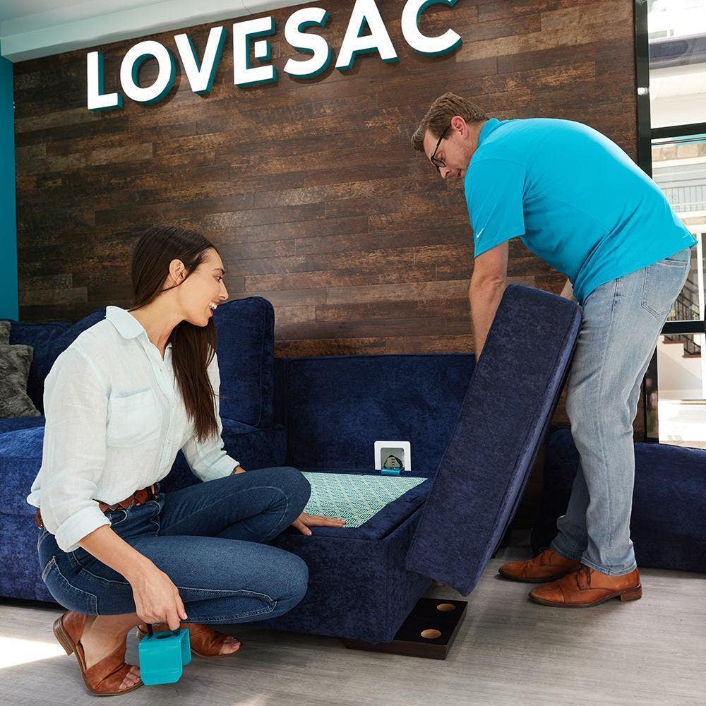Couple adjusting their Lovesac Sactional.