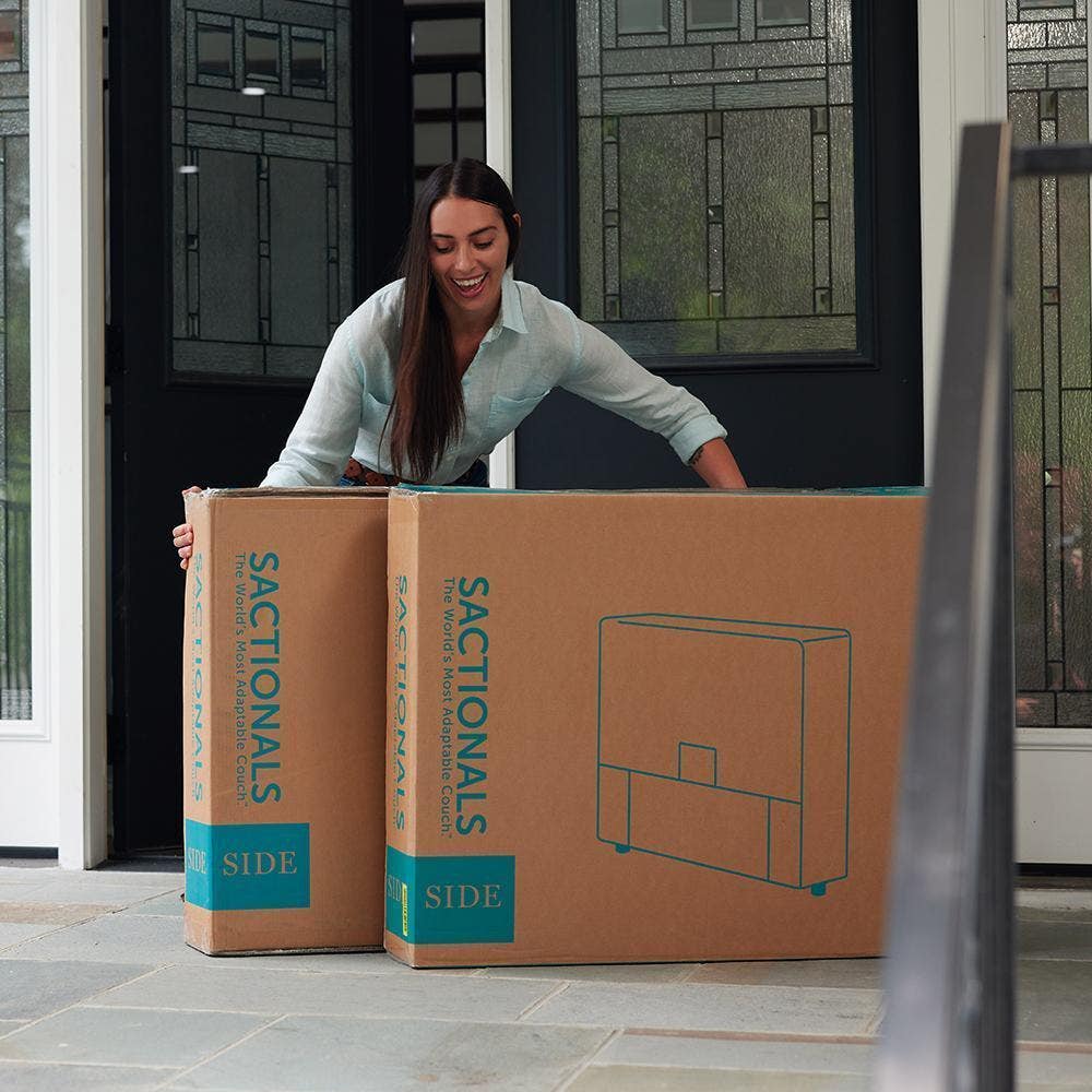 Woman moving her Lovesac Sactional delivery boxes.