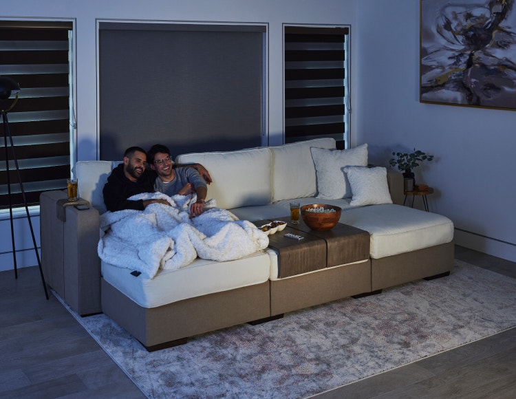 Couple relaxing on a couch experiencing the StealthTech product