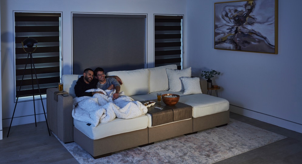 Couple relaxing on a couch experiencing the StealthTech product