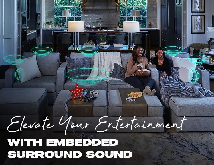 Two People Relaxing on Lovesac Sactional with StealthTech Surround Sound in Living Room