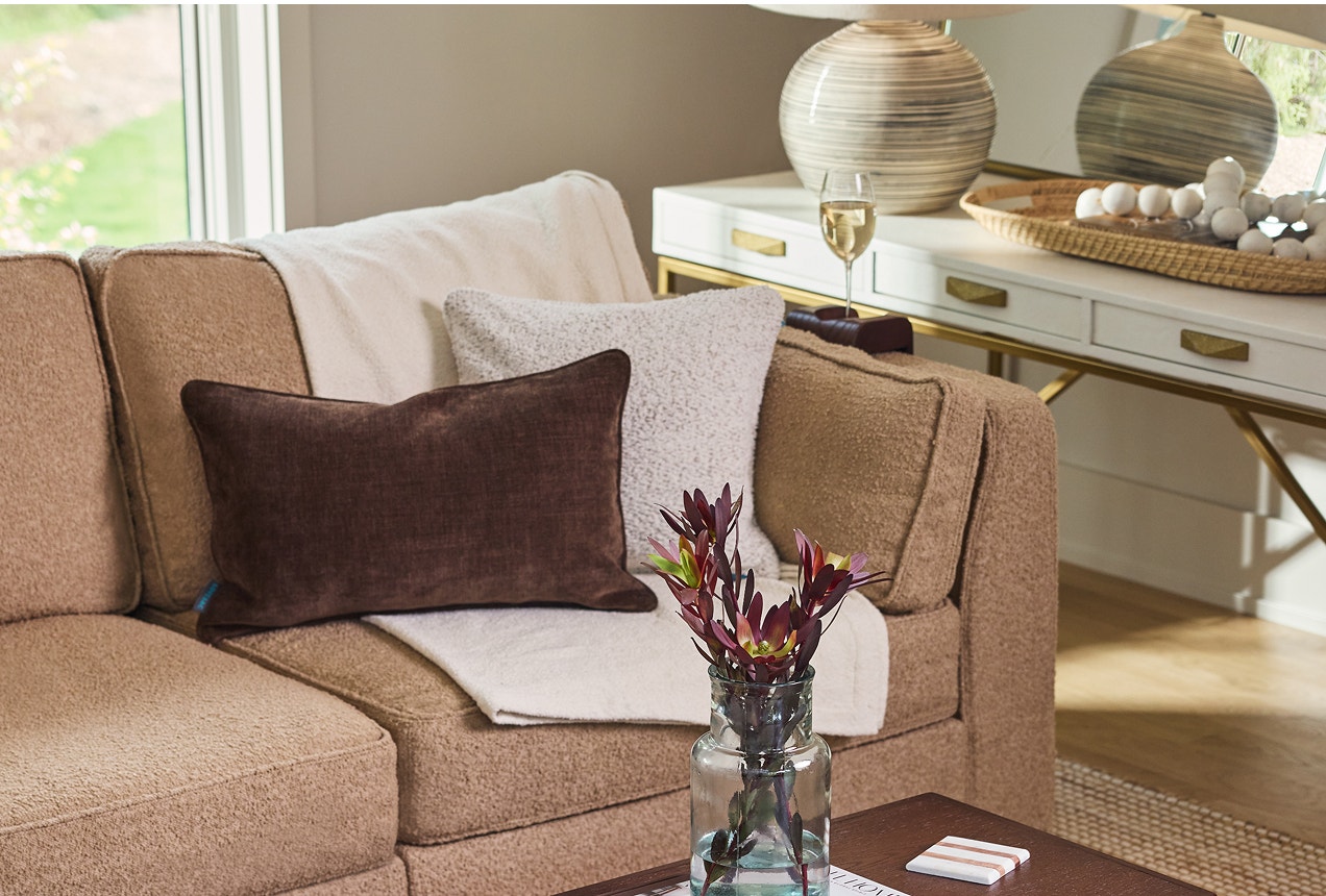 Lovesac Throw Pillows arranged on a tan sectionals couch
