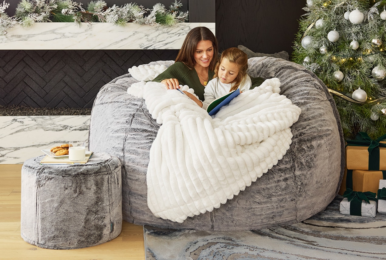 Woman Upgrading Lovesac Sactional with StealthTech Subwoofer