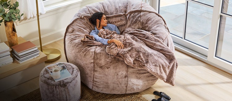 Woman relaxing on a Lovesac Beanbag Chair