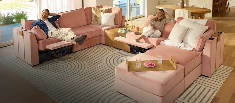 Couple changing the covers on their green Lovesac sectional couch