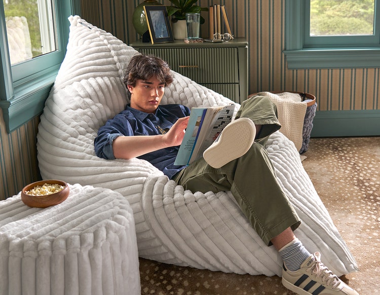 Woman relaxing on a Lovesac PillowSac beanbag chair