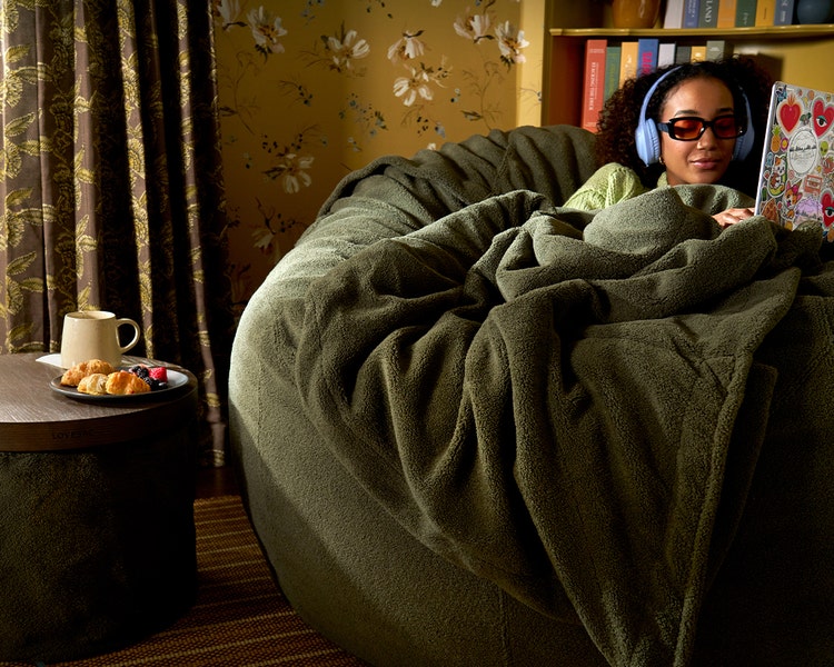 Woman relaxing in her peach colored Lovesac beanbag chair