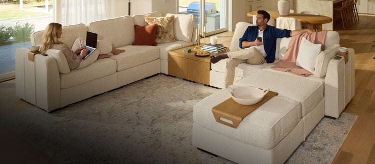 Family relaxing on a green Lovesac sectional couch