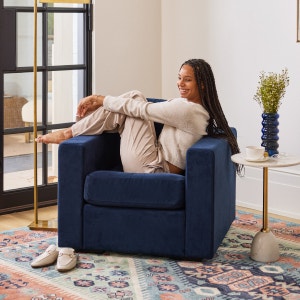 Woman relaxing on a blue chair in a living space