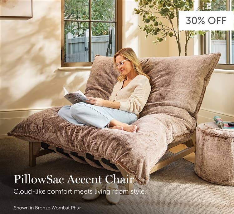 Woman relaxing in a bronze, Lovesac Pillowsac Accent Chair in a living room