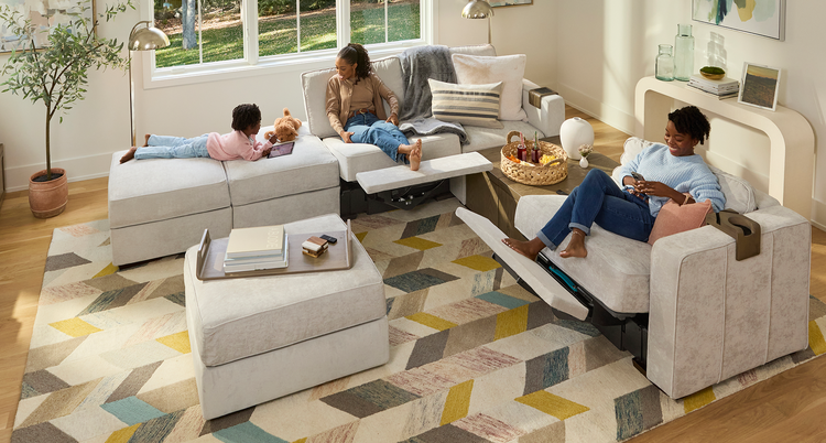 Family relaxing on their Lovesac sectional couch with a reclining seat