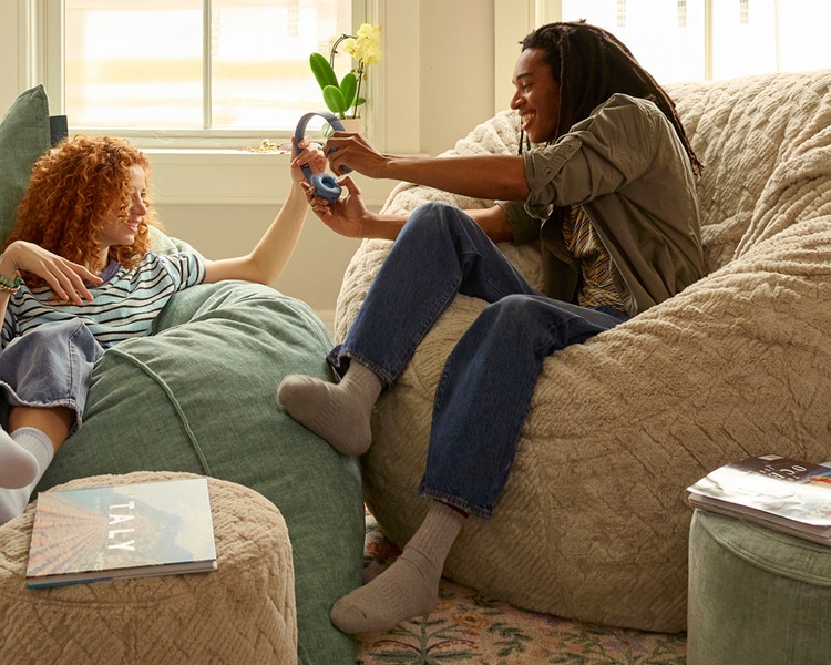 Woman relaxing in her peach colored Lovesac beanbag chair