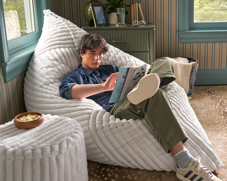 Mom and young son relaxing in their white Lovesac beanbag chair
