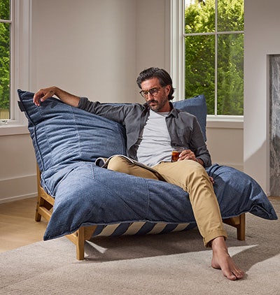 Woman relaxing on a Lovesac beanbag chair