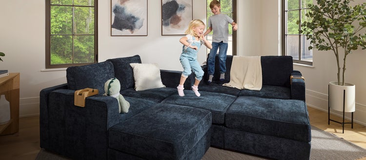 Couple changing the covers on their green Lovesac sectional couch
