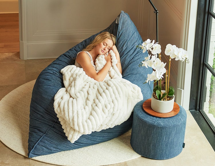 Woman relaxing on a Lovesac PillowSac beanbag chair