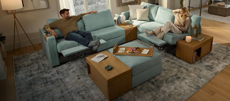 Man and woman arranging a sectional couch