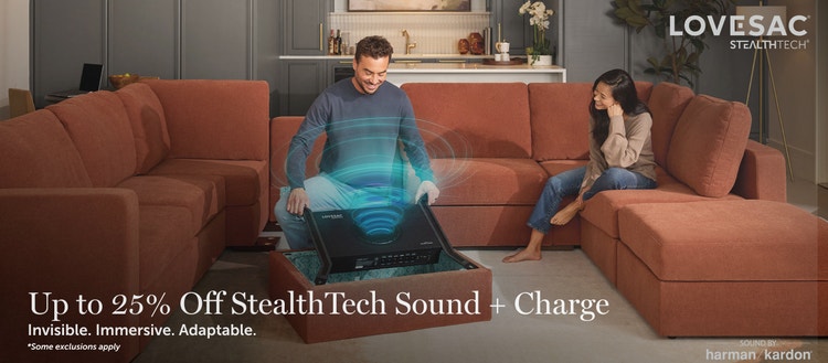 Man and child on a Lovesac sectional couch with embedded StealthTech speakers