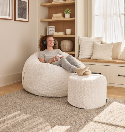 Woman relaxing on a Lovesac beanbag chair