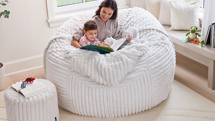Mom and young son relaxing in their white Lovesac beanbag chair