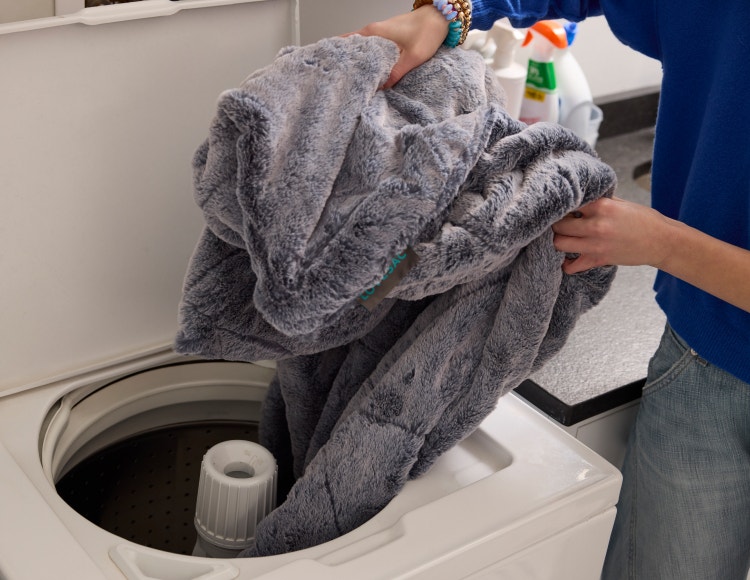 Person cleaning their bean bag cover in a washing machine