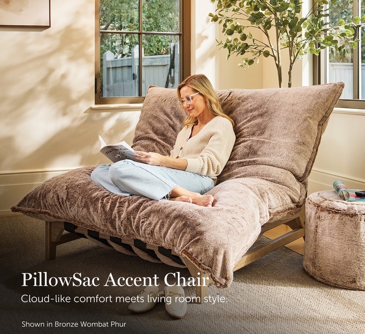 Woman relaxing in a bronze, Lovesac Pillowsac Accent Chair in a living room