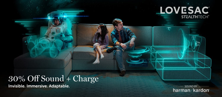 Man and child on a Lovesac sectional couch with embedded StealthTech speakers