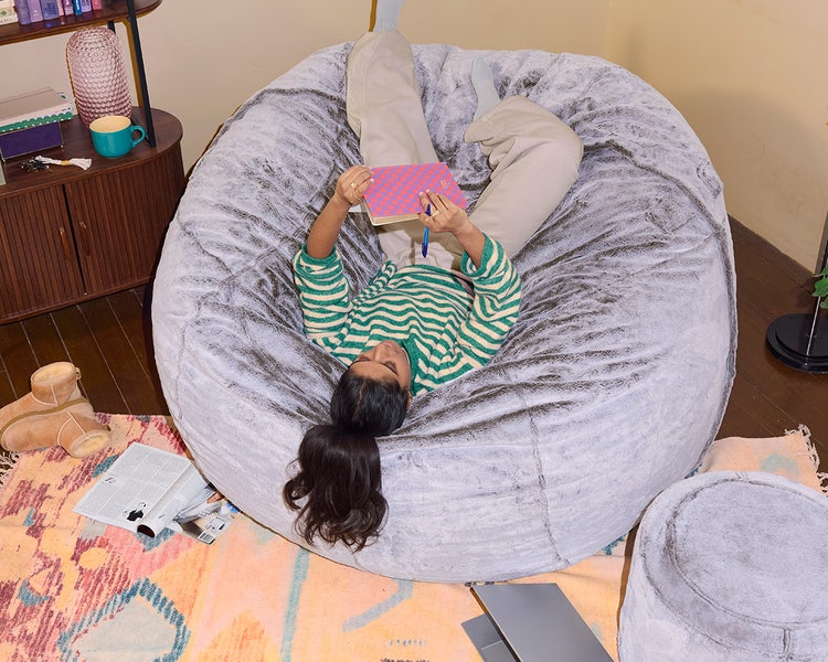 Mom and young son relaxing in their white Lovesac beanbag chair