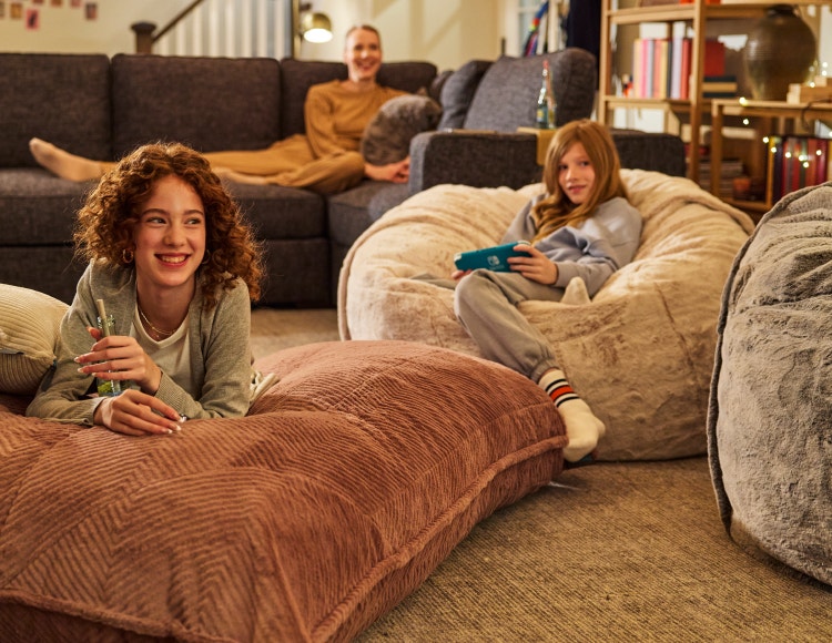 Kids playing video games on their Lovesac bean bag chairs