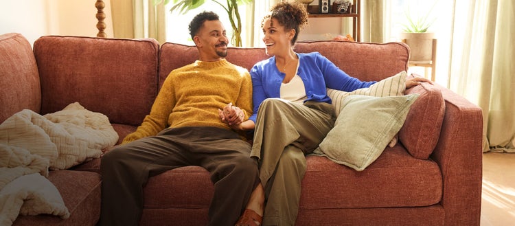Man and woman arranging a sectional couch