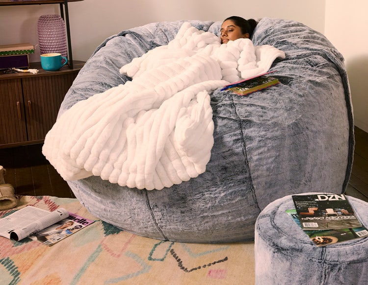 Woman relaxing on a Lovesac PillowSac beanbag chair