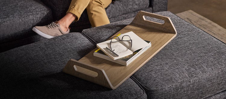 Brown Lovesac tray table with grey sectional couch