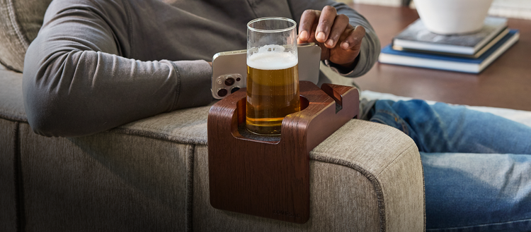 Dark brown Lovesac drink holder on sectional couch arm