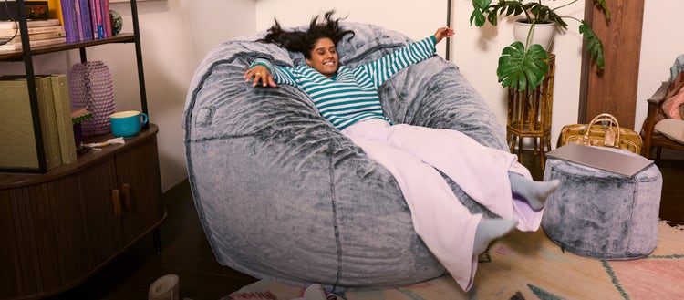 Child playing on a Lovesac bean bag chair.